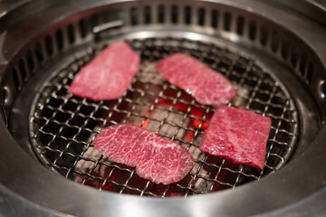 Various type of Japanese style sliced rare beef meat on charcoal grill