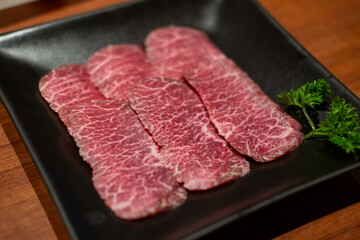 Japanese style sliced rare beef brisket meat on the plate