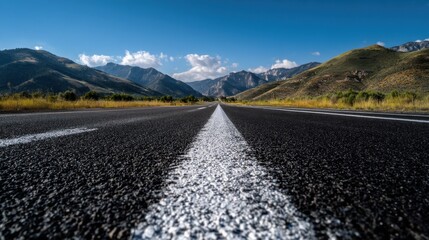Black asphalt road with clear white lane markings, extending toward the horizon, realistic and detailed.