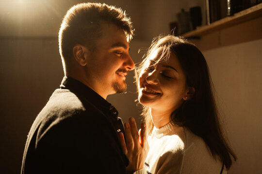 silhouette of loving couple kiss, creating an intimate atmosphere at home indoors