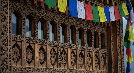 Bhutanese carved wooden window with prayer flags