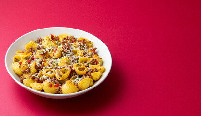 Pasta with bolognese sauce and cheese. Italian cuisine. Traditional recipe.