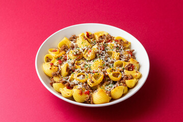 Pasta with bolognese sauce and cheese. Italian cuisine. Traditional recipe.