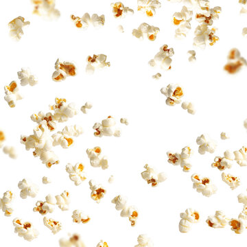 Scattered crispy popcorn falling motion on a bright white backdrop