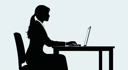 Silhouette of a Woman Working on a Laptop at a Desk.