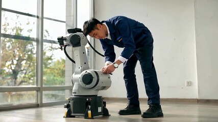 Engineer working on a robotic arm in a modern office setting.