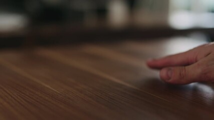 Slow motion woodworker checking oil finish on black walnut