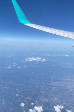 Airplane glides smoothly above Earth&rsquo;s bright horizon.