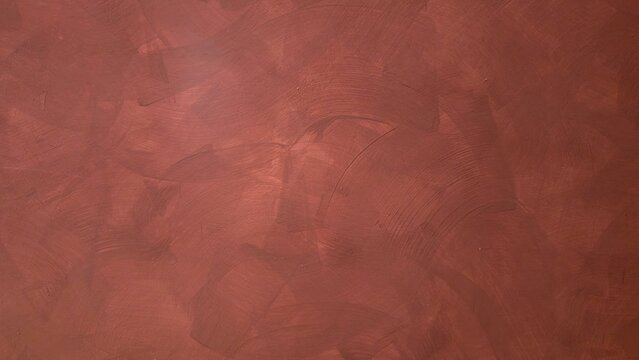 Dark red and black background, painted concrete wall texture, rough uneven plaster. A wall painted in vintage red. Cement concrete wall texture.