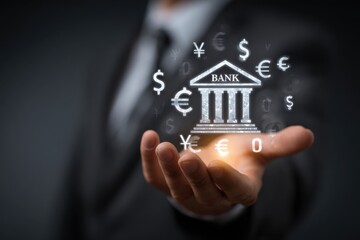 A hand holding a virtual bank building icon with various currency symbols on a dark background.