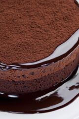 Piece of delicious chocolate cake with mint and fork on table, closeup