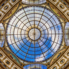 Glass dome of Galleria Vittorio Emanuele II with ornate metal structure and geometric architectural...