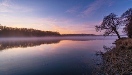 Obraz premium Winter sunrise over a wild lake, showcasing seasonal change
