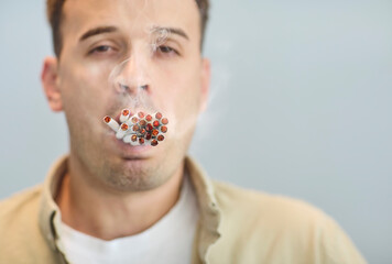 Man, cigarettes, smoker, addiction, nicotine, tobacco, smoke. A male portrait with a mouthful of...