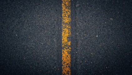 Rough asphalt surface with a dark grey tarmac and yellow line, suitable for background use