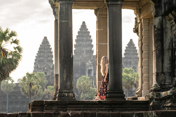 Woman traveling angkor wat admiring ancient temple architecture