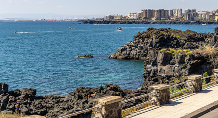 La Scogliera, 7kms north of Catania, Sicily. As a result of ancient lava flows from Mt Etna, it is known for its volcanic rock formations and is a popular sightseeing and swimming location.