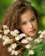 Fototapeta premium Portrait of beautiful young girl in park in spring