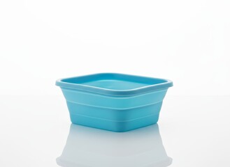 Blue silicone foldable food container on clean white background
