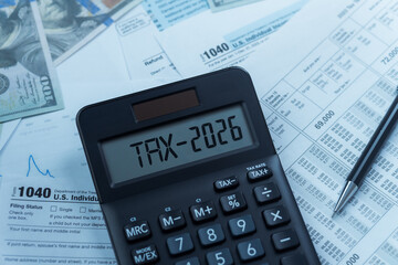 2026 Taxes on Calculator with 1040 Income Tax Form and W-2 Payroll Statement. Tax Concepts covers...