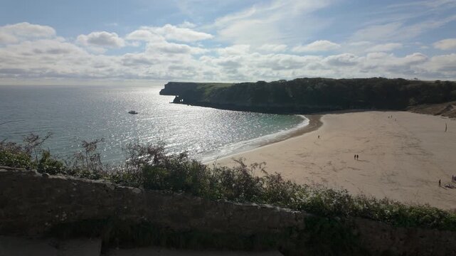 Summertime establishing shot of Barafundle Bay Beach on the Pembrokeshire coast, Wales.