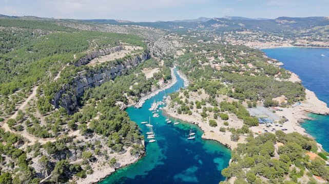 Calanque de Port Miou on the Mediterranean coast near Cassis Village, South of France. Aerial drone view of Calanques National Park. Narrow fjord with sail boats moored