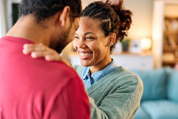 Portrait of a lovely young couple together, bonding hugging and relaxing at home