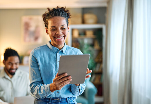 Portrait of a young black man and woman, a young couple, or businessman and businesswoman, using tablet and laptop in home office, business and teamwork, cooperation and brainstorming concept - Powered by Adobe