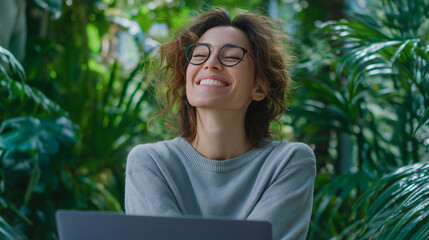 Joyful Woman with Glasses in Lush Greenhouse