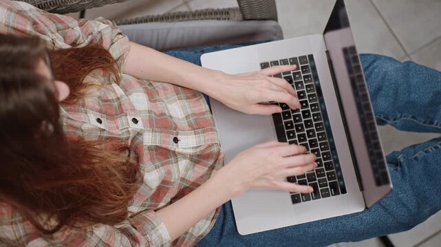 Top view young woman sitting with a laptop, the hands of an unrecognizable woman typing on a laptop keyboard, chatbot promt, web surfing, e-learning, research students, social networking, chatting 