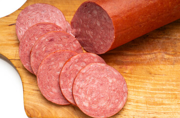 Close-up of sliced ​​smoked sausage on a kitchen board
