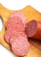 Close-up of sliced ​​smoked sausage on a kitchen board