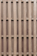 Natural textured background of dark brown plank and panel wood wall, featuring real processed wood board and plank material, for rustic, farmhouse, vintage design theme as a backdrop or copy space