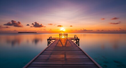 Fototapeta premium Wooden Pier with Bench Overlooking Ocean at Vibrant Sunset.
