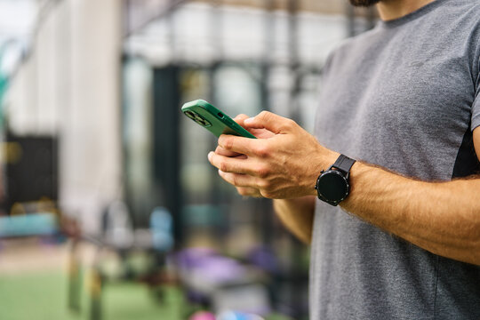 Portrait of a young black man using a phone ant exting taking a break exercising in a gym, having a training workout in gym, healthy lifestyle and cardio exercise at fitness club concepts - Powered by Adobe