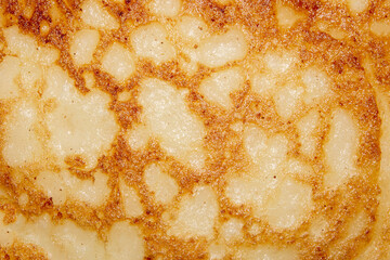 Pancakes texture.Pancakes background.Homemade Russian pancakes with a golden crust.Pancakes from the heat from the heat.