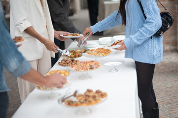 Guests enjoy a delectable spread of appetizers and desserts at a sophisticated private event buffet...