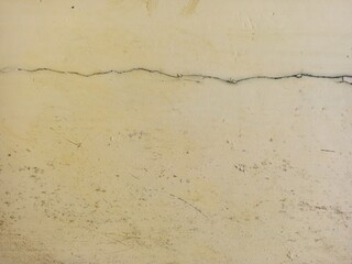 Horizontal Thick Crack On Faded Beige Painted Wall Texture