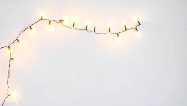 Warm white string lights on a clean white background, perfect for festive designs, holiday greetings, or cozy ambiance. Copy space for text or graphics.