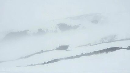 Snow-covered mountain peaks during a heavy blizzard or whiteout fog. 【Generative AI】
