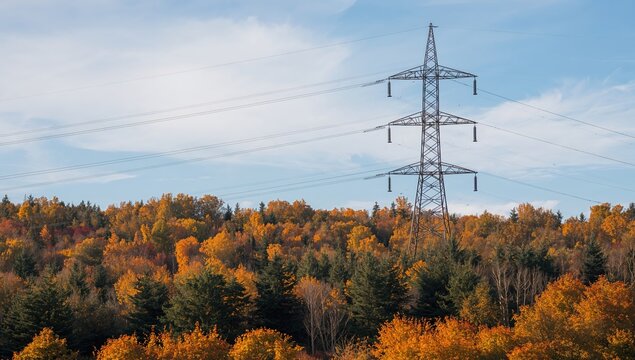 Autumn landscape featuring energy truss tower, highlighting technological infrastructure in nature