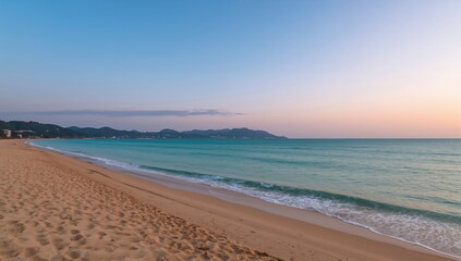 Obraz premium Tranquil sunset at a serene beach with gentle waves and soft autumn hues, ideal for relaxation