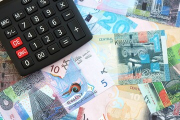 Kuwaiti dinar currency money bills and calculator close up. The concept of taxation and money count
