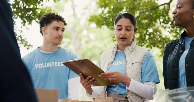 Clipboard, conversation and food drive with volunteer people outdoor charity or community service. Collaboration, donation and planning with group talking in park for ngo or non profit mission
