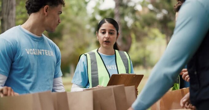 NGO, volunteers and people with clipboard, park and listening to organizer for social responsibility. Outdoor, group and coordinator with checklist for inventory, donations and supply distribution