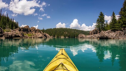 Landscape featuring blue water, rocky terrain, and trees with a kayaking activity focus, outdoor adventure