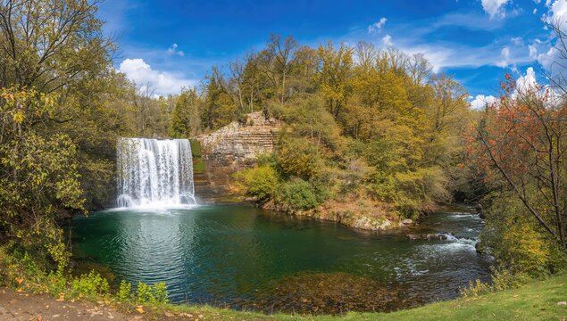 Serene swimming area adjacent to a cascading waterfall, ideal for relaxation