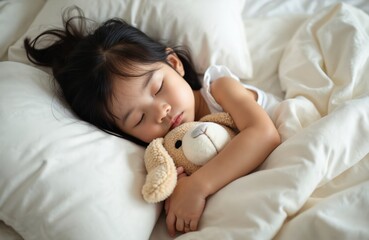 Asian toddler sleeps peacefully in bed with stuffed dog toy. Child enjoys comfortable nap on fresh bedding within cozy bedroom setting. Sweet dreams, relaxation are evident in this heartwarming scene.
