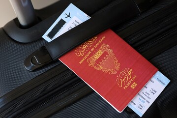 Bahraini passport and avia tickets on travel bag close up. The concept of travel and vacation