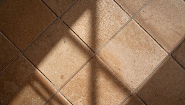 Sandstone floor tiles casting shadows, creating a sharp contrast of light